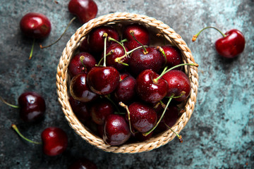 Fresh cherries in a basket. top view