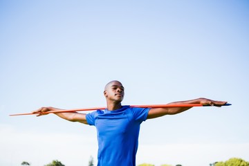 Fototapeta na wymiar Athlete standing with javelin