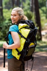 Woman front the back smiling and turning around to the camera