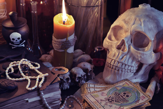 Close up of skull, candlebook and the tarot cards