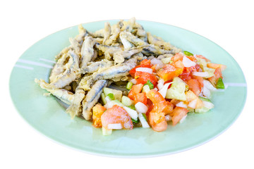 Fried fish wit vegetables on plate