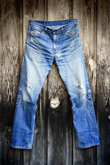 old blue jeans on aged wood