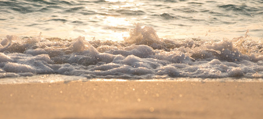 Fototapeta na wymiar Sea wave on sand beach. Sunset sunrise ray. Sunset sunrise twili