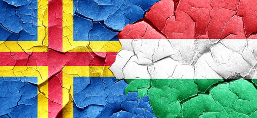aland islands with Hungary flag on a grunge cracked wall