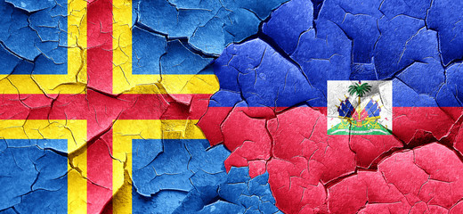 aland islands with Haiti flag on a grunge cracked wall