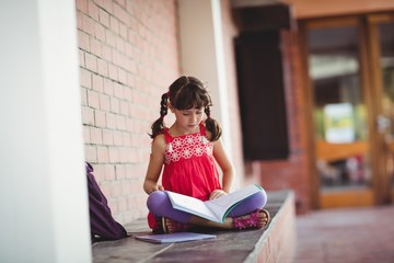Girl reading a book outside