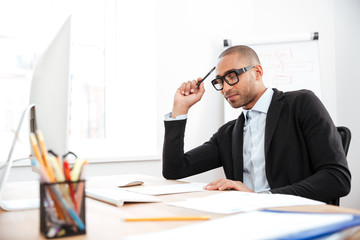 Young handsome businessman thinking about work