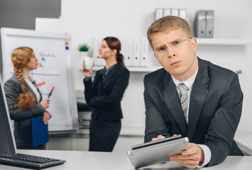 handsome businessman calculating at calculator