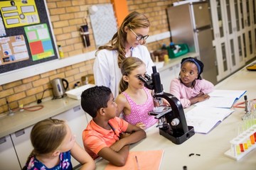 Teacher giving lesson to her students