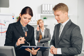 male manager instructs female employee