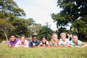 Smiling kids posing together during a sunny day