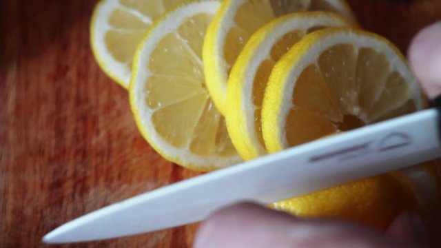Lemon Cut on a Board With a Knife