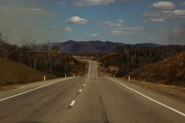 Empty road in a hilly area. Landscape. Autumn, early spring.