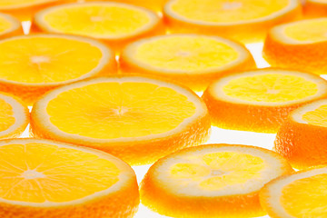 Glowing orange slices on a white background. Pattern. Fruit background.