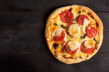 Pizza with tomatoes, cheese and bazil