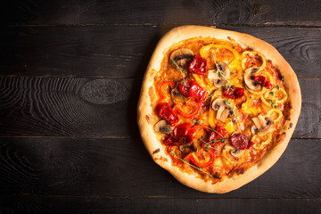 Vegan pizza with sun-dried tomatoes (top view)