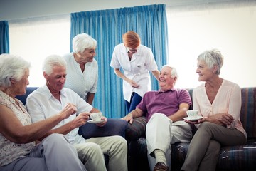 Fototapeta premium Seniors interacting with nurse
