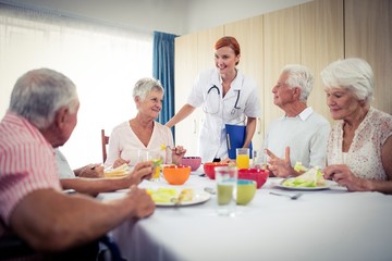 Pensioners at lunch with nurse