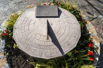 stone sundial with iron needle - obrazy, fototapety, plakaty