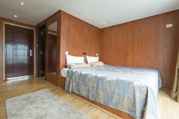 Fototapeta na wymiar Interior of a cabin bedroom on cruise boat hotel