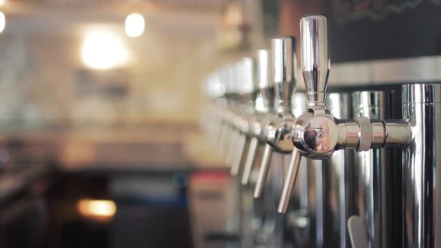 Draft Beer Tap Handles In Pub. A beer tap is a valve, specifically a tap, for controlling the release of beer.