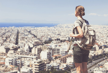 Traveler woman looking on a big city, travel and active lifestyle concept