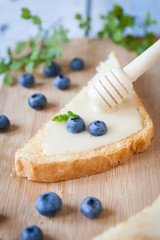Sandwiches with cream honey and blueberries