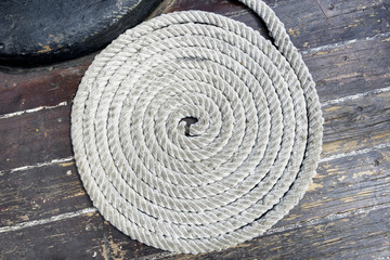 Fototapeta na wymiar Spirally arranged, the rope on the deck of an old yacht.