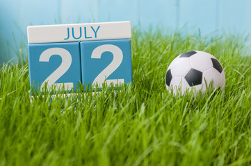July 22nd. Image of july 22 wooden color calendar on greengrass lawn background. Summer day, empty...