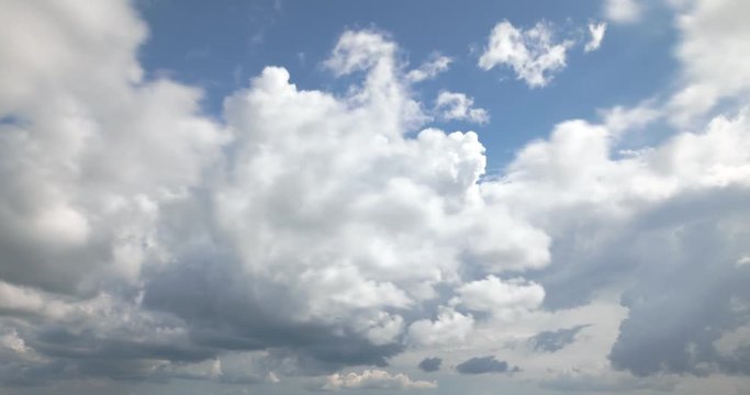 puffy and wooly clouds pass through sky forming rain clouds