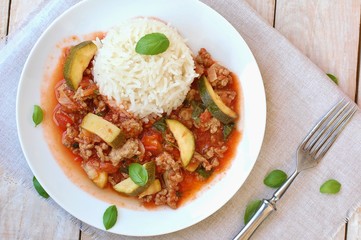 Spicy mincemeat with tomatoes, basil and zucchini with basmati rice