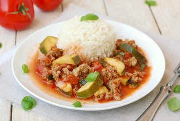 Spicy mincemeat with tomatoes, basil and zucchini with basmati rice