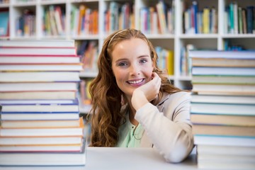 Portrait of smiling school teacher in library