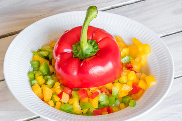 Sliced pepper on a plate on a wooden table