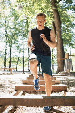 Full length of man exercising at outdoor gum