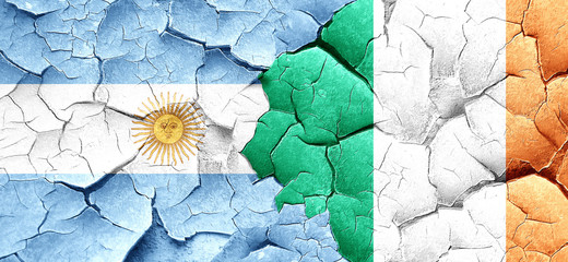 Argentina flag with Ireland flag on a grunge cracked wall