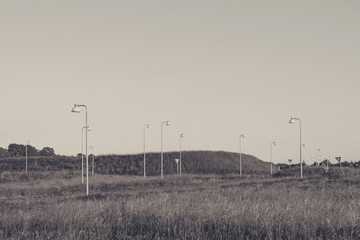 Many streetlamps on a meadow