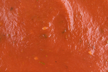Close view of pizza sauce illuminated with natural light.