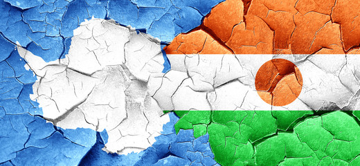 antarctica flag with Niger flag on a grunge cracked wall