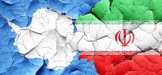 antarctica flag with Iran flag on a grunge cracked wall