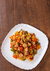 Rice with Vegetables and Meat in a plate on wooden table