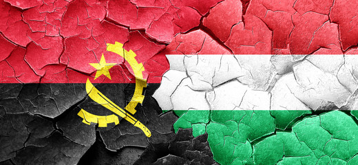 Angola flag with Hungary flag on a grunge cracked wall