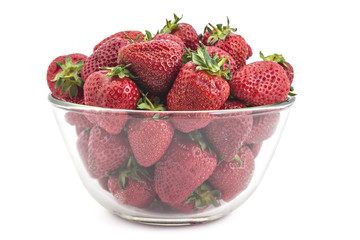 Fresh organic strawberries in the glass bowl, isolated on white background