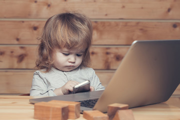 Small boy with computer and phone