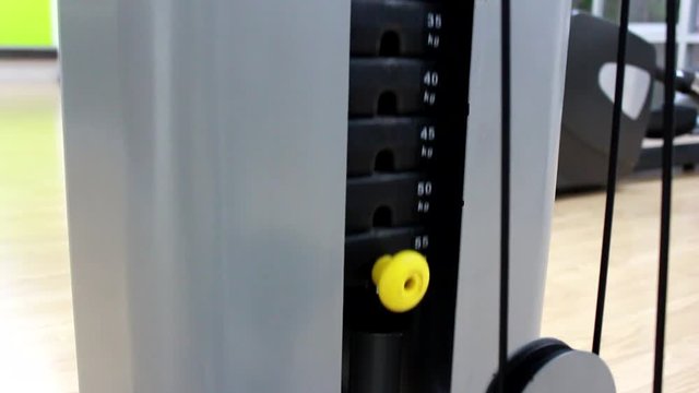 weight stacks in gym lifted motion. iron weights 55 kgs. Camera in motion