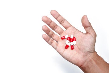 capsule on hand on white background