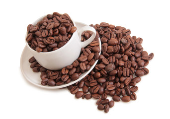 Coffee beans and cup on white background