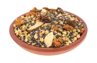 Bowl of chia seeds nuts and fruit breakfast cereal isolated on a white background side view.