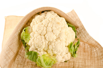 Cauliflower with burlap sack on white