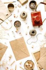 flay lay composition. freelancer retro brown style workspace with vintage photo camera, craft envelope, pencils, tools and twine on white background.